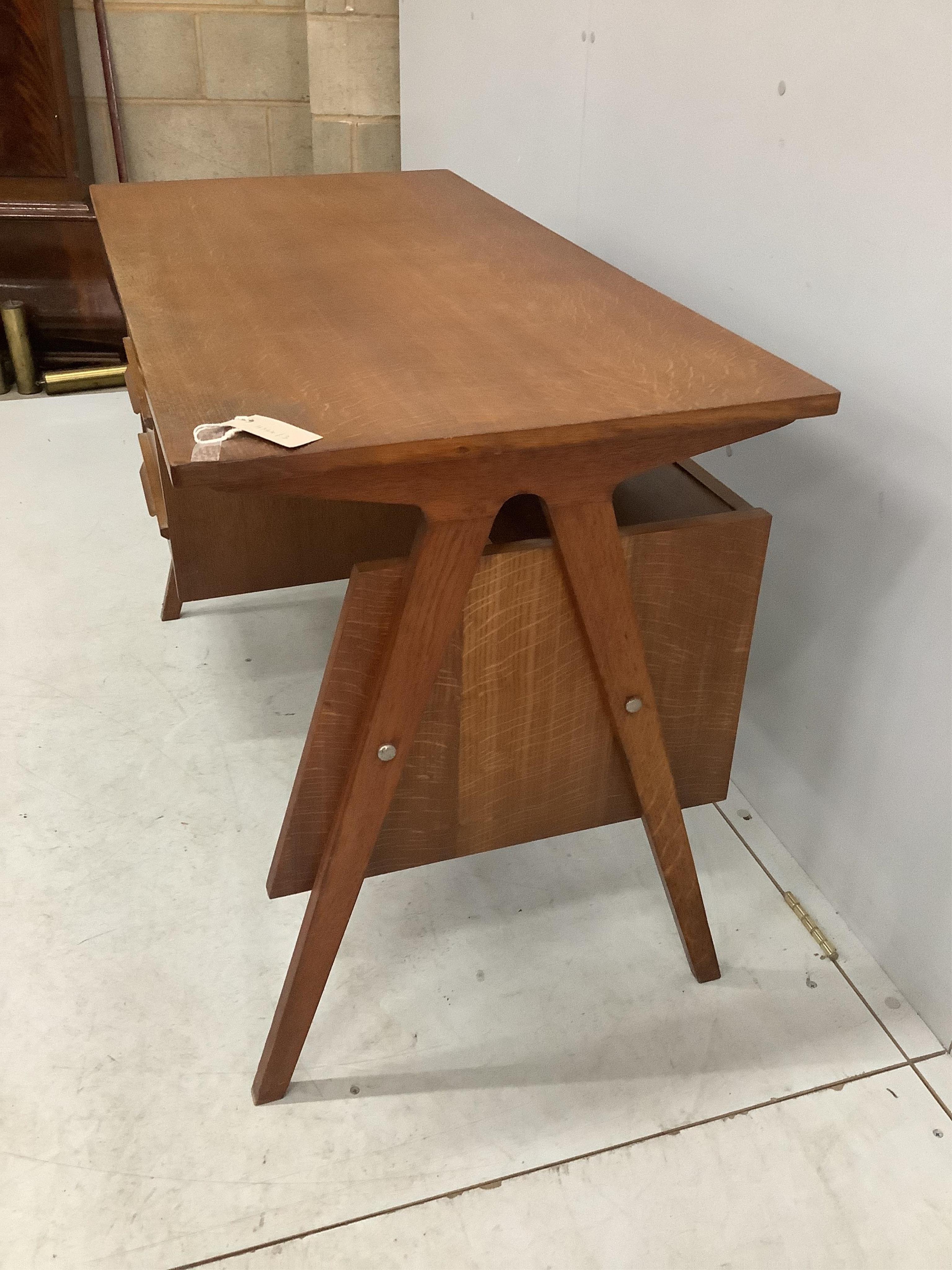 In the manner of Robin Day, a 'Hillstak' type oak desk, width 110cm, depth 55cm, height 71cm. Condition - fair